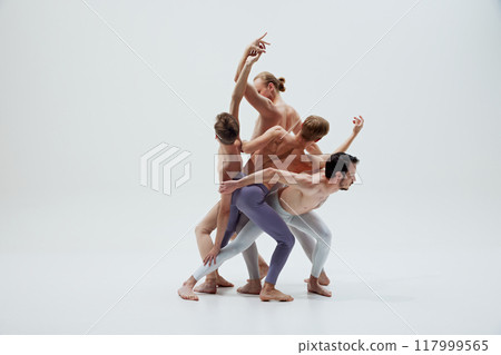 Ballet dancers' bodies form composition, each movement reflecting balance and unity against white studio background. Ballet dancers' bodies form composition, each movement reflecting balance and unity against white studio background. 117999565