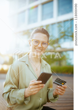 happy woman employee in green blouse and eyeglasses happy woman employee in green blouse and eyeglasses 118000490