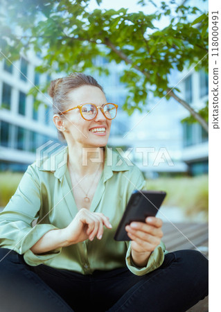 business woman in green blouse and eyeglasses using phone business woman in green blouse and eyeglasses using phone 118000491