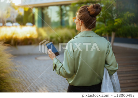 Seen from behind female worker near office building 118000492