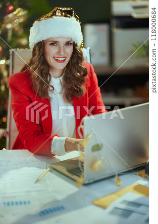 happy elegant small business owner woman in red jacket working 118000684