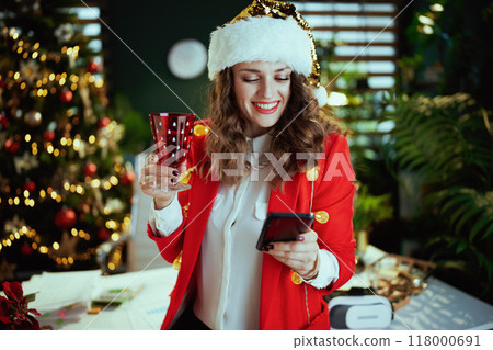 smiling stylish business woman sending text message using phone 118000691