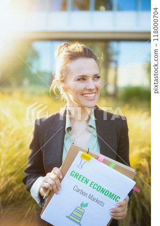 smiling modern female worker near business center 118000704