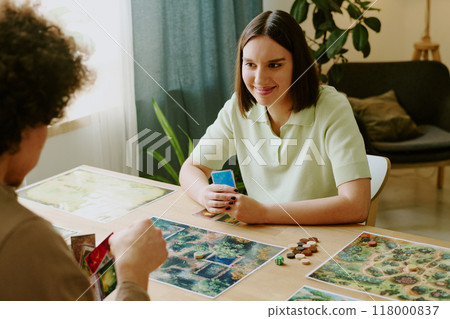 High angle shot of young woman playing modern fantasy board game with her boyfriend in living room 118000837