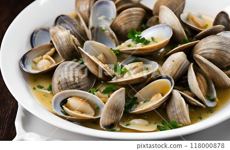 Littleneck clams in a savory white wine sauce with fresh herbs, delivering a juicy succulent seafood experience. A delicious and flavorful dish that's both satisfying and refined.  AI Generated 118000878