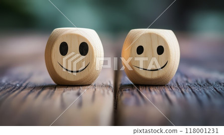 Wooden smiley faces on a rustic wooden table in natural light 118001231