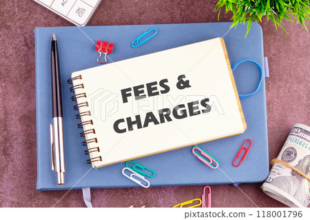Business concept. FEES and CHARGES words in a notebook in a composition with office supplies, top view 118001796