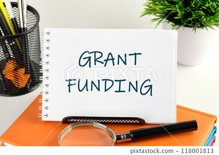 Business financing and grants concept. Copy space. GRANT FUNDING handwritten text in a notebook, notepad 118001813