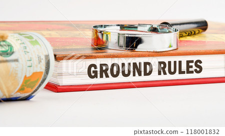 Conceptual ground rules symbol. Copy space. GROUND RULES words written on the end of the book on a white background in a composition with a magnifying glass and American dollar bills Conceptual ground rules symbol. Copy space. GROUND RULES words written on the end of the book on a white background in a composition with a magnifying glass and American dollar bills 118001832
