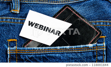 WEBINAR words written on a white card peeking out of a business card holder in a jeans pocket 118001844