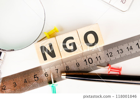 NGO (Non-Governmental Organization) sign on wooden cubes next to the measuring ruler 118001846