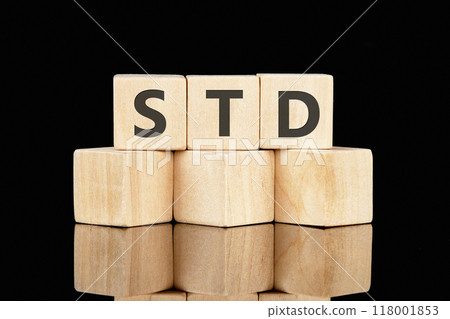 STD Sexually Transmitted Diseases. STD on wooden cubes on a glossy black background 118001853