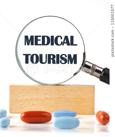 MEDICAL TOURISM written close-up through a magnifying glass. Front view MEDICAL TOURISM written close-up through a magnifying glass. Front view 118001877