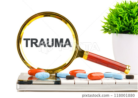 TRAUMA written an inscription on a light background was found through a magnifying glass TRAUMA written an inscription on a light background was found through a magnifying glass 118001880