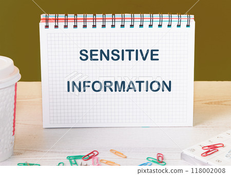 Conceptual sensitive information symbol. Copy space. Sensitive information message written on a blank page of a checkered notebook Conceptual sensitive information symbol. Copy space. Sensitive information message written on a blank page of a checkered notebook 118002008