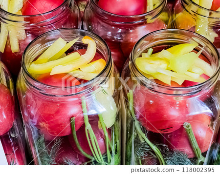 Glass jars with tomatoes for preservation. Canning vegetables at home. Organic products Glass jars with tomatoes for preservation. Canning vegetables at home. Organic products 118002395