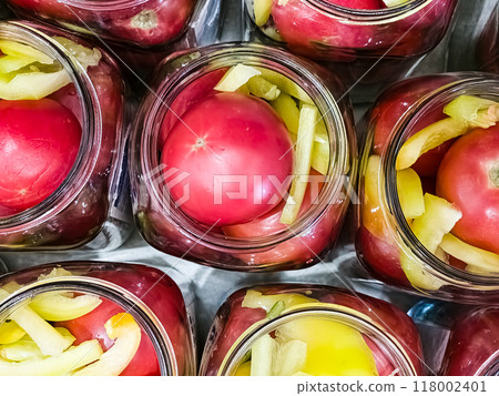 Glass jars with tomatoes for preservation. Canning vegetables at home. Organic products 118002401