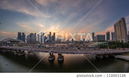 Aerial view over Helix Bridge and Bayfront Avenue with traffic day to night timelapse at Marina Bay, Singapore 118003186