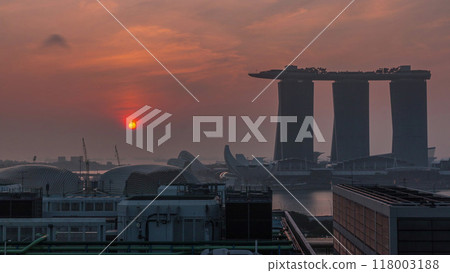 Sunrise near Marina Bay Sands Hotel dominates the skyline at Marina Bay in Singapore aerial timelapse. 118003188