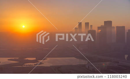 Abu Dhabi city skyline with skyscrapers at sunrise from above timelapse 118003240