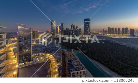 Buildings on Al Reem island in Abu Dhabi day to night timelapse from above. 118003243