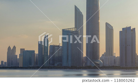 Abu Dhabi city skyline with skyscrapers after sunrise with water reflection timelapse Abu Dhabi city skyline with skyscrapers after sunrise with water reflection timelapse 118003262