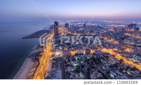 Cityscape of Ajman from rooftop night to day timelapse. Ajman is the capital of the emirate of Ajman in the United Arab Emirates. Cityscape of Ajman from rooftop night to day timelapse. Ajman is the capital of the emirate of Ajman in the United Arab Emirates. 118003269