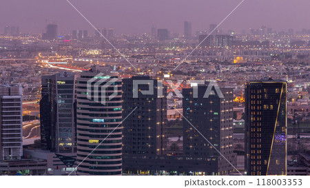 Dubai's business bay towers at evening aerial day to night timelapse. Dubai's business bay towers at evening aerial day to night timelapse. 118003353