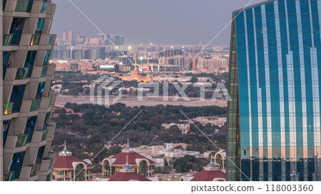 Aerial view to neighborhood Deira and Dubai creek with typical old and modern buildings day to night timelapse. 118003360