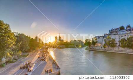 Rear view of Notre Dame De Paris cathedral at sunset with sun in the frame timelapse. Rear view of Notre Dame De Paris cathedral at sunset with sun in the frame timelapse. 118003502
