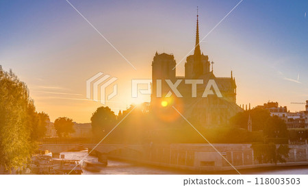 Rear view of Notre Dame De Paris cathedral at sunset with sun in the frame timelapse. Rear view of Notre Dame De Paris cathedral at sunset with sun in the frame timelapse. 118003503