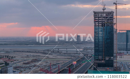 Sunrise aerial view of Financial center road morning timelapse with under construction building Sunrise aerial view of Financial center road morning timelapse with under construction building 118003522