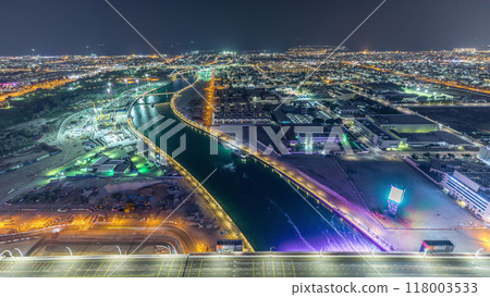 Dubai water canal with footbridge aerial night timelapse from Downtown skyscrapers rooftop 118003533