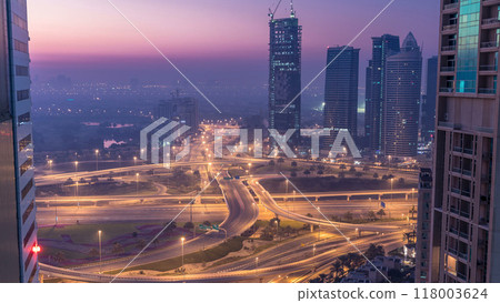 Aerial view of a road intersection in a big city night to day timelapse. 118003624