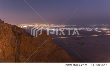 Day to night timelapse with rocks from Jebel Hafeetwith impressive view over the city. Day to night timelapse with rocks from Jebel Hafeetwith impressive view over the city. 118003844
