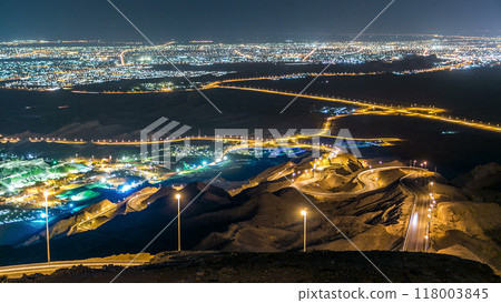 Night timelapse with rocks from Jebel Hafeetwith impressive view over the city. Night timelapse with rocks from Jebel Hafeetwith impressive view over the city. 118003845