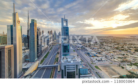 Dubai skyscrapers sunset timelapse evening time. Dubai Metro station and traffic on Sheikh Zayed Road 118003864