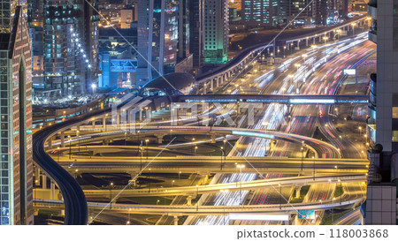Aerial view of highway junction with traffic timelapse in Dubai, UAE, at night. Famous Sheikh Zayed road in Dubai downtown. 118003868