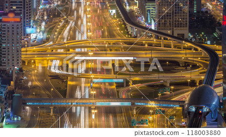 Aerial view of highway junction with traffic timelapse in Dubai, UAE, at night. Famous Sheikh Zayed road in Dubai downtown. Aerial view of highway junction with traffic timelapse in Dubai, UAE, at night. Famous Sheikh Zayed road in Dubai downtown. 118003880