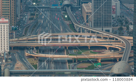 Aerial view of highway junction with traffic timelapse in Dubai, UAE, at sunset. Famous Sheikh Zayed road in Dubai downtown. 118003884