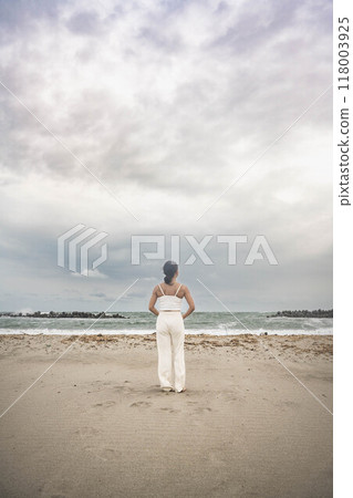 Young woman doing yoga on the beach Young woman doing yoga on the beach 118003925