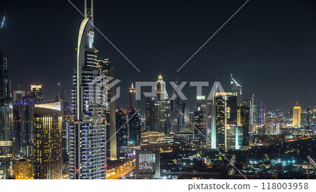 Dubai downtown skyline timelapse at night. Rooftop view of Sheikh Zayed road with numerous illuminated towers. Dubai downtown skyline timelapse at night. Rooftop view of Sheikh Zayed road with numerous illuminated towers. 118003958