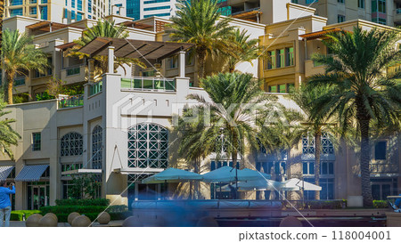 Fountain and palms timelapse at the Marina walk during day time. Dubai, UAE Fountain and palms timelapse at the Marina walk during day time. Dubai, UAE 118004001