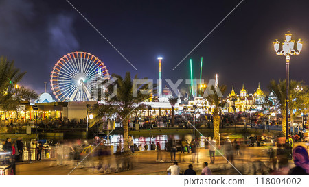 Main square and lake in Global Village with crowd and attractions timelapse in Dubai, UAE 118004002