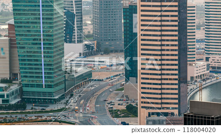 Top view of road in Dubai downtown timelapse with day traffic and business bay skyscrapers. 118004020
