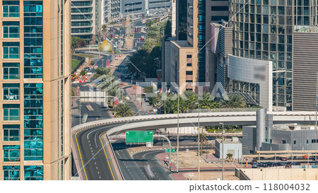 Aerial view of a highway intersection in Dubai, UAE, at day time with traffic timelapse. Aerial view of a highway intersection in Dubai, UAE, at day time with traffic timelapse. 118004032