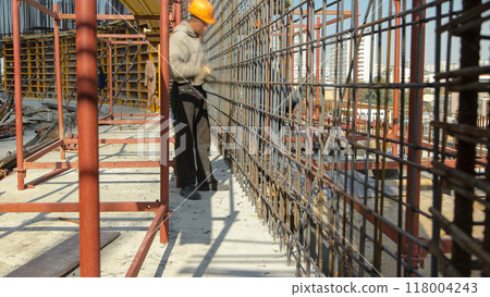 Construction workers working on steel rods used to reinforce concrete timelapse Construction workers working on steel rods used to reinforce concrete timelapse 118004243