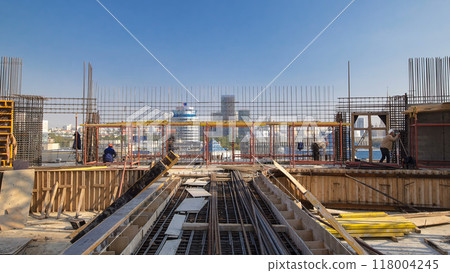 Construction workers working on steel rods used to reinforce concrete timelapse 118004245