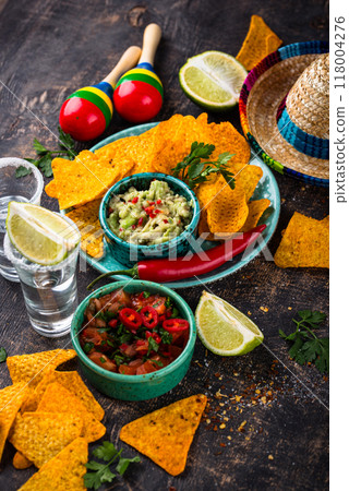 Traditional Mexican food nachos, salsa, guacamole, tequila. 118004276