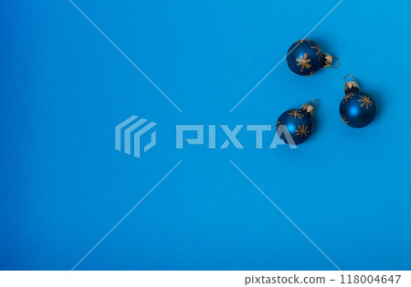 Christmas composition. three blue balls with gold stars on a blue background. Flat lay, top view 118004647